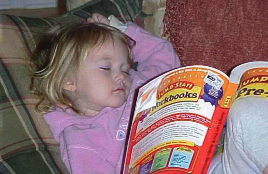 Emily falls asleep while reading a book.