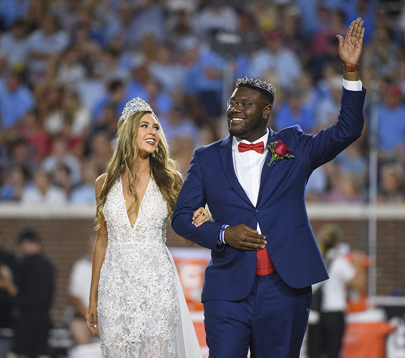 Carl Tart waves to the crowd at Vaught-Hemmingway Stadium along with Ciara Knapp.