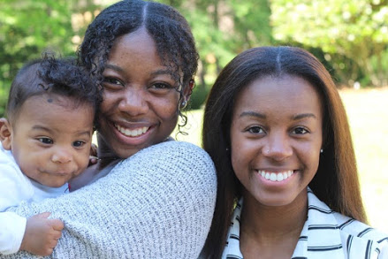 Lauren Hamme with her younger sister and god nephew posing for a photo.