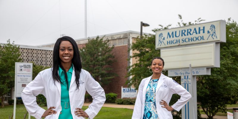 Brianca Fizer and Andrea Washington pose for a photo outside of Murrah High School