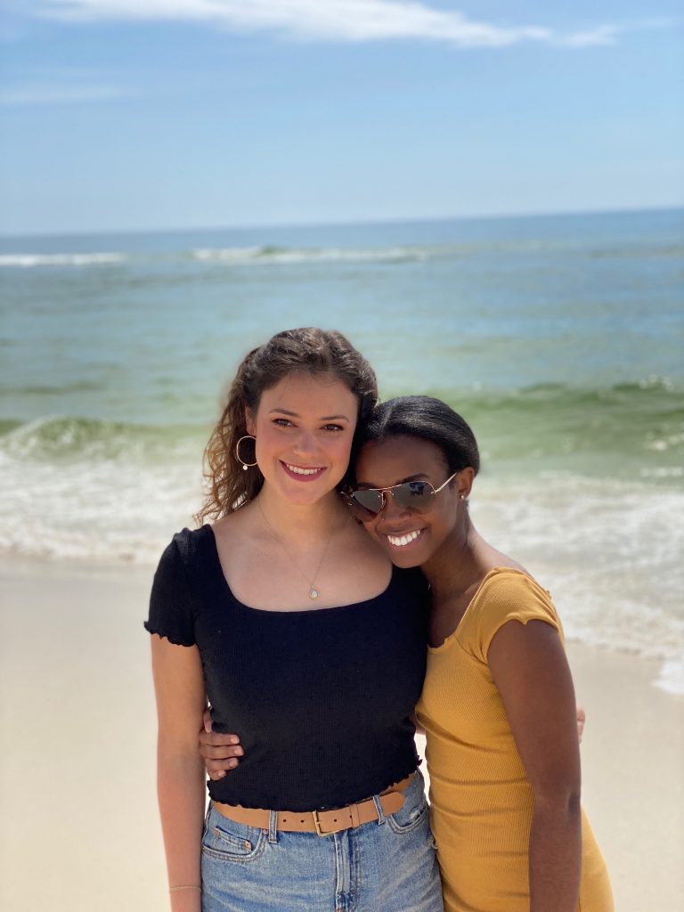 Lauren Hamme poses for a picture with her friend on the beach