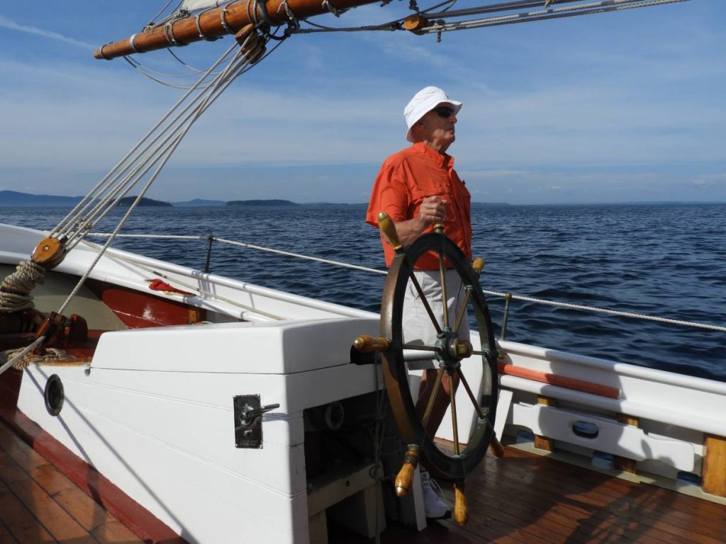 Cliff at the helm of his boat