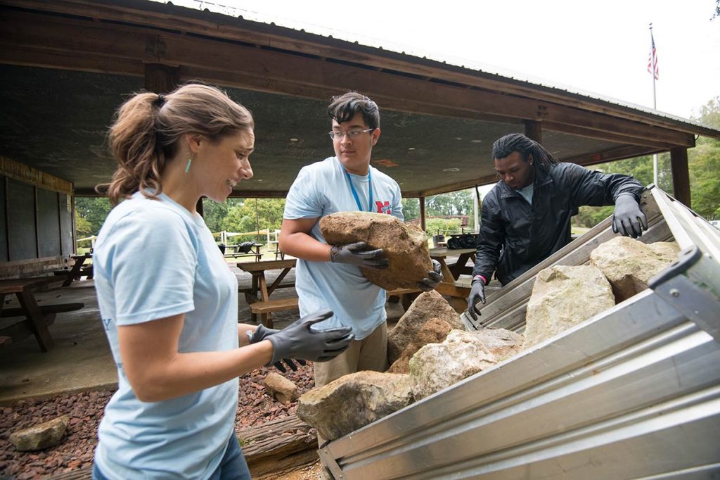 Bernardo Guerro (center) joins Luckyday scholars and other university peers in community service in New Albany during the 2018 M Partner Community Day of Service. Photo by Kevin Bain/Ole Miss Digital Imaging Services