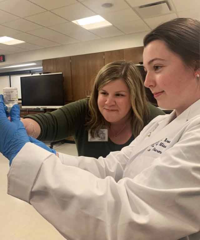 Kreusel with Jordan Ballou, clinical associate professor of pharmacy practice, in skills lab. Submitted photo