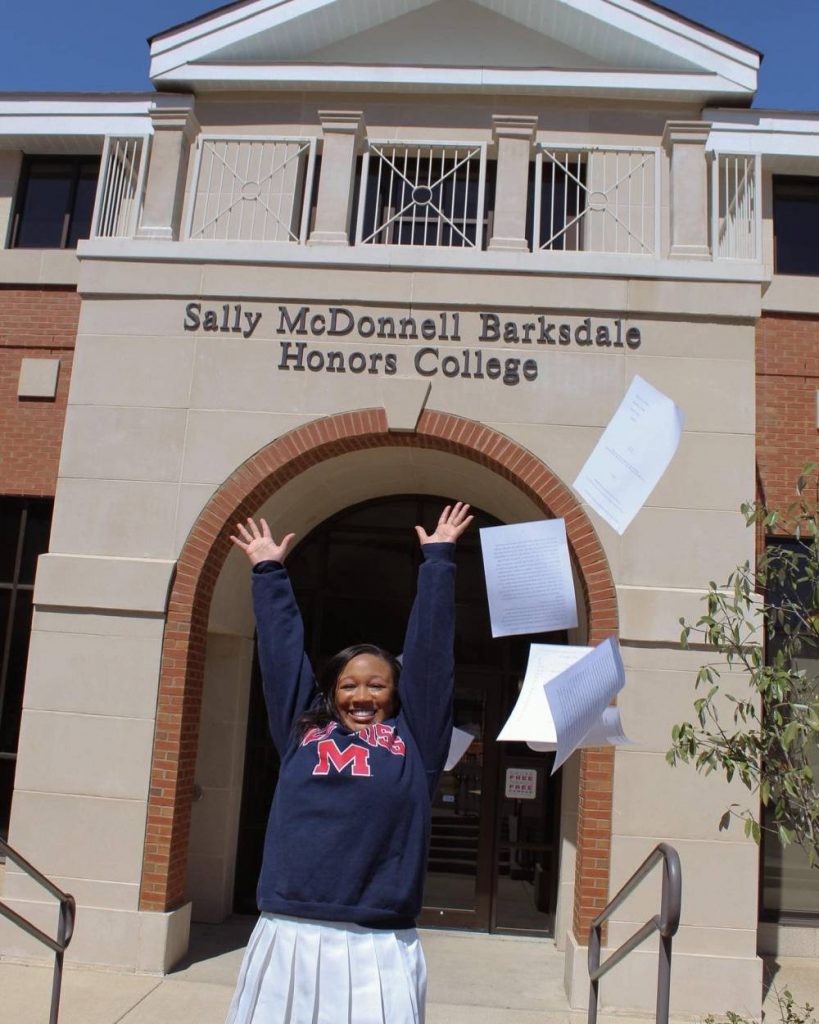 Bowens celebrates outside of the Sally McDonnell Barksdale Honors College. 