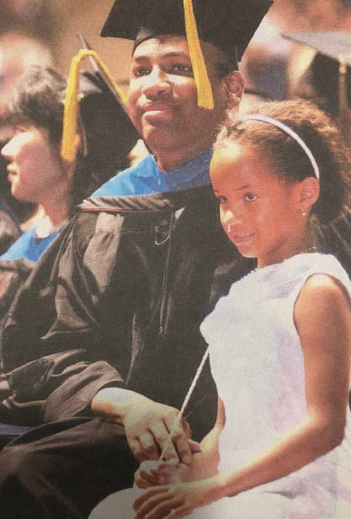 Joseph Meredith (left) in cap and gown and young Jasmine Meredith