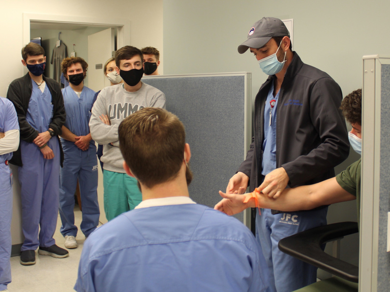 JoJo Dodd, right, gives a phlebotomy lesson to other students before the start of a Jackson Free Clinic day in 2021.