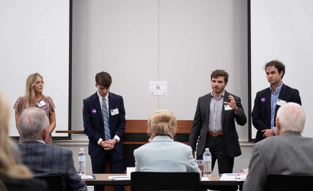 Members of the Rumie team – (from left) Sam Pennock, Carson Zylic, Patrick Phillips and Tanner McCraney – make their pitch to judges in the final round of the Gillespie Business Plan competition. The group took first place in the competition with their buy/sell app for college students. Photo by Logan Kirkland/Ole Miss Digital Imaging Services