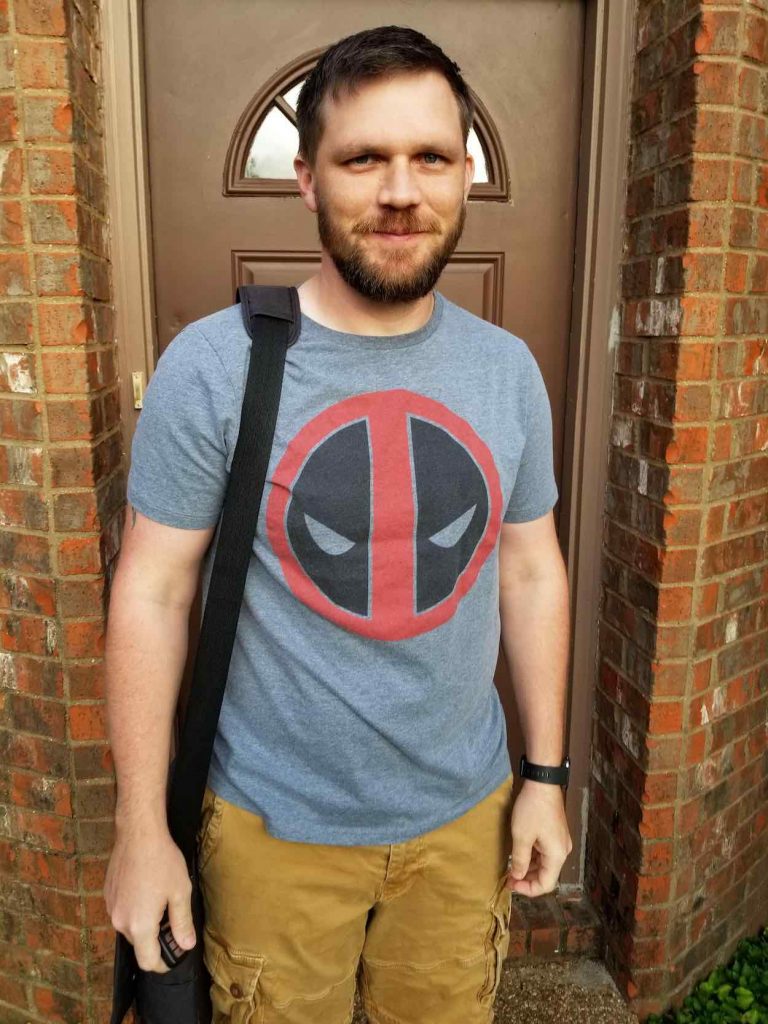 Jamie stands in front of his front door with a backpack on his shoulder as he gets ready to leave for his first day of school.