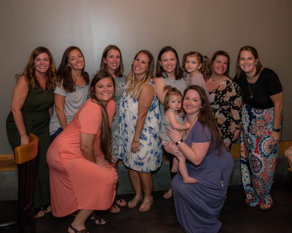 Jori, her sister and friends are dressed up at a dinner.