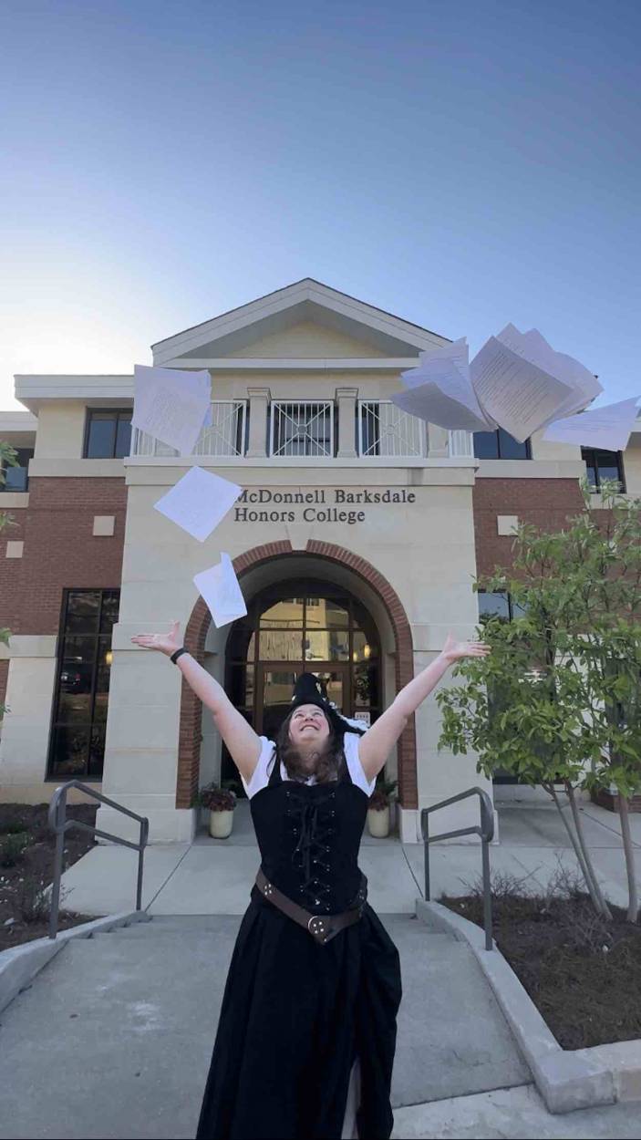 Harris celebrates in front of the Sally McDonnell Barksdale Honors College after her successful honors thesis defense. Submitted photo